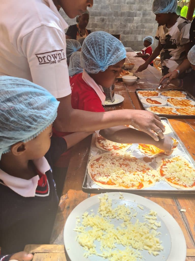 Children at a hands-on food workshop on a school trip