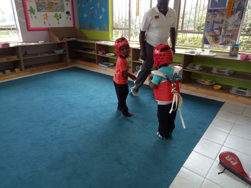 Children in a taekwondo lesson with their coach
